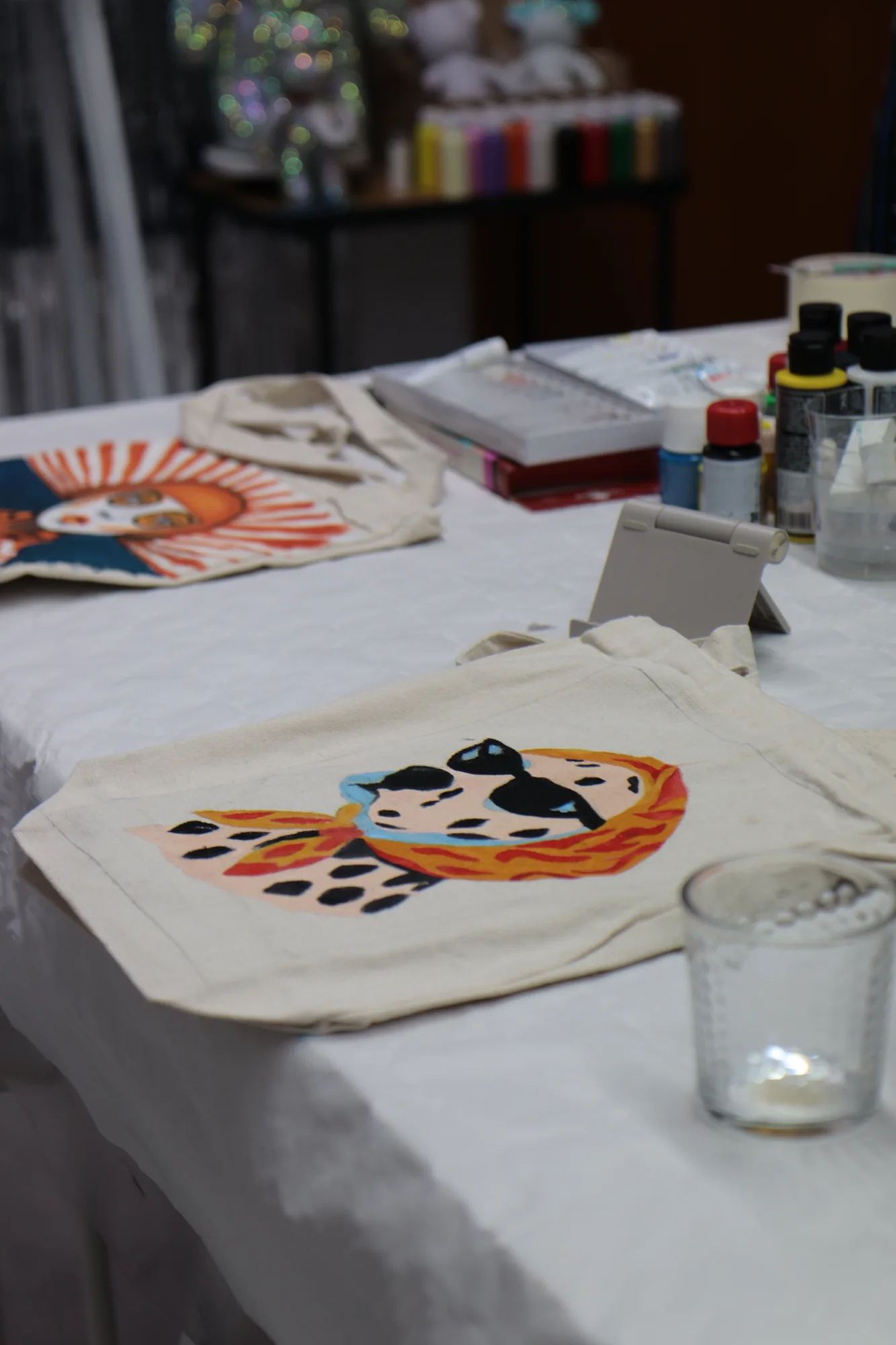 Close-up of a hand-painted tote bag in the studio